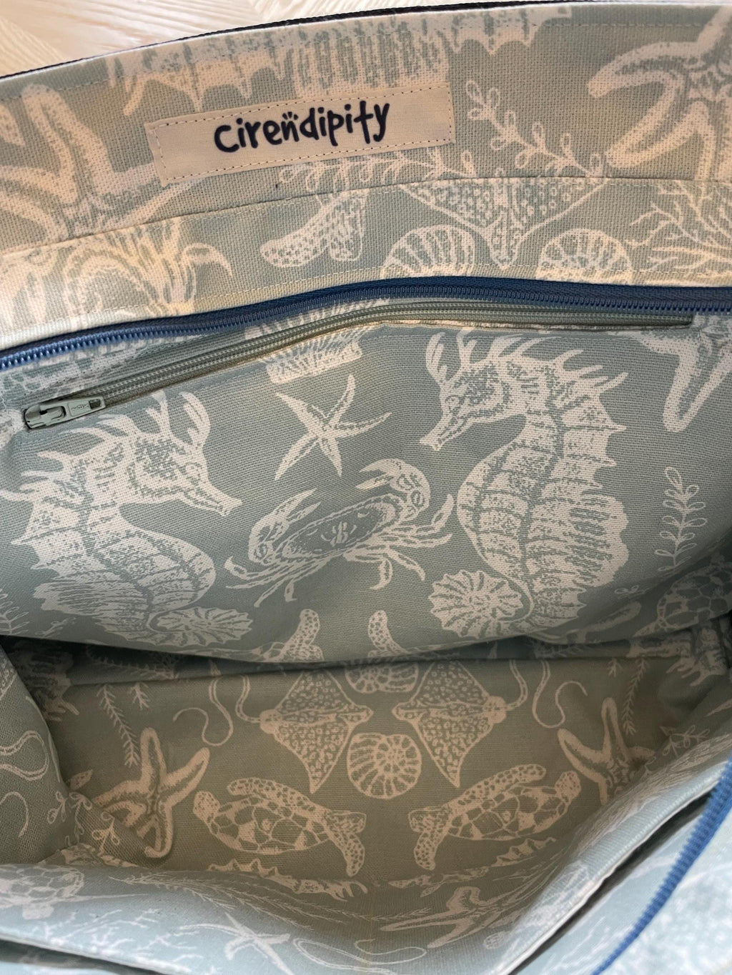 Handmade recycled zip top patchwork denim tote bag with aquarium fabric lining