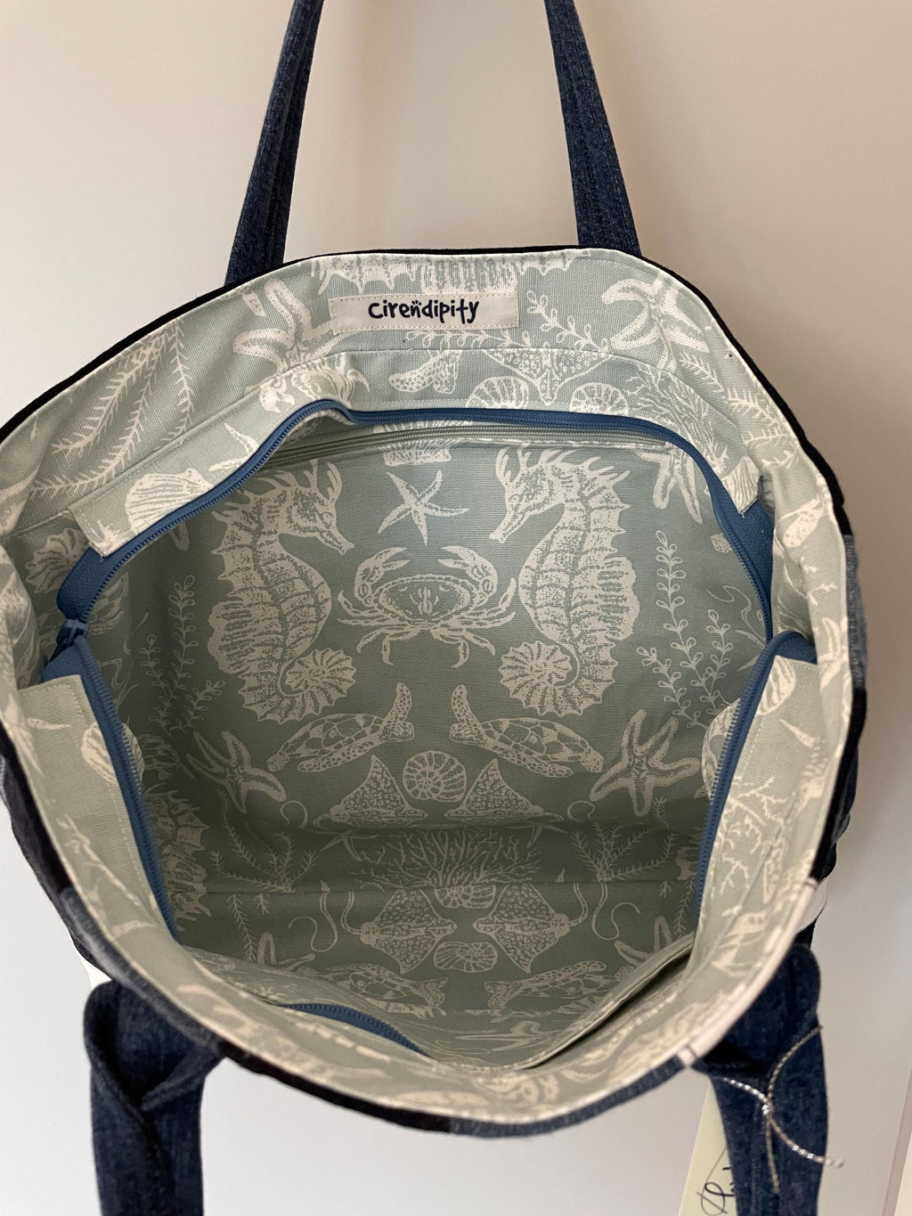 Handmade recycled zip top patchwork denim tote bag with aquarium fabric lining