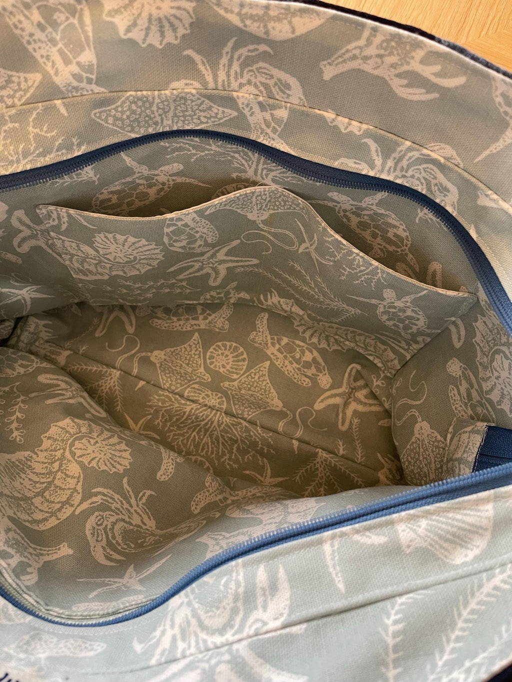Handmade recycled zip top patchwork denim tote bag with aquarium fabric lining