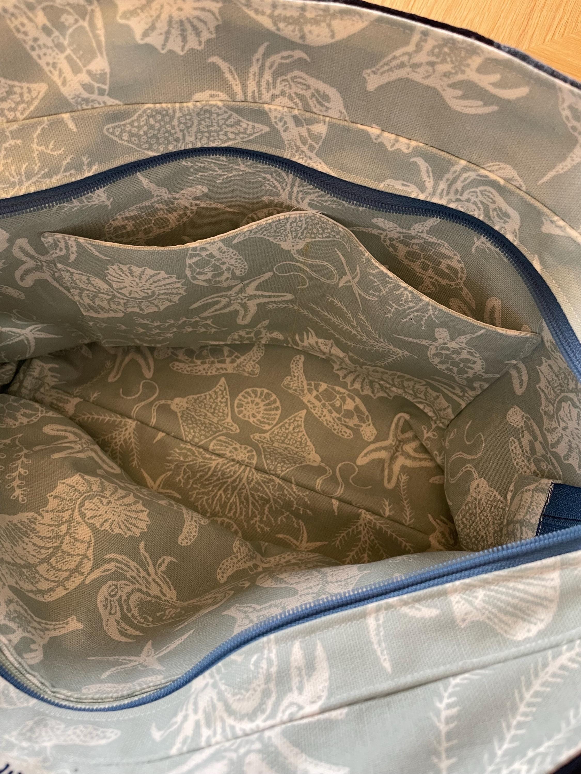 Handmade recycled zip top patchwork denim tote bag with aquarium fabric lining