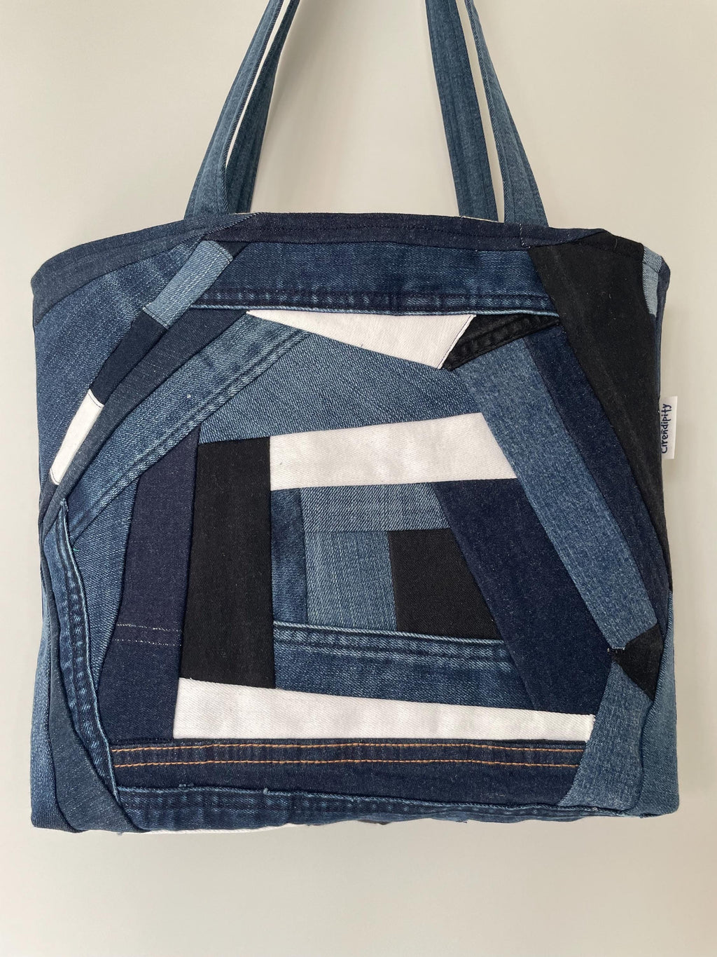 Handmade recycled patchwork denim tote bag with Sophie Allport bees fabric lining